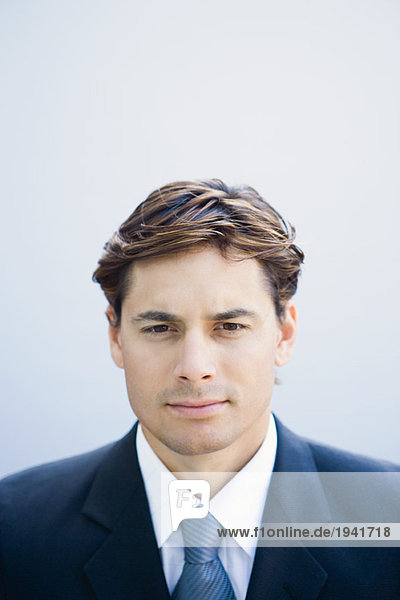 Young businessman looking at camera  portrait  head and shoulders