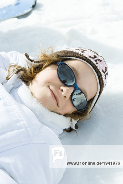 Girl lying in snow  portrait