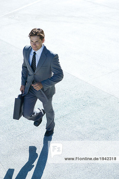 Businessman carrying briefcase  walking