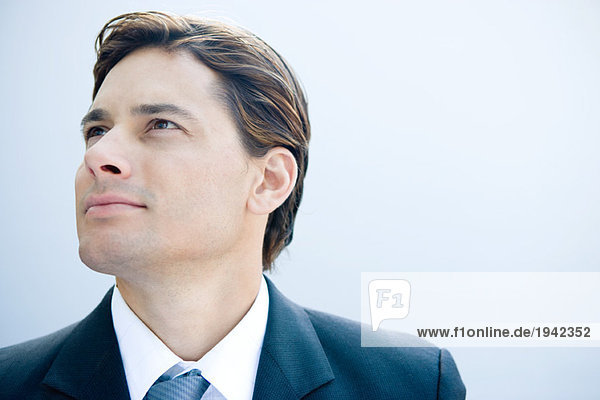 Businessman looking up  head and shoulders  portrait