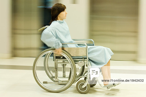 Frau im Rollstuhl  volle Länge  verschwommene Bewegung