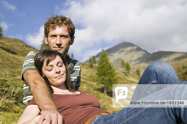 Young couple resting in mountains