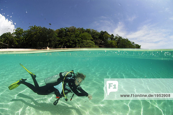 Philippines  Dalmakya Island  woman scuba diver in sea  underwater view