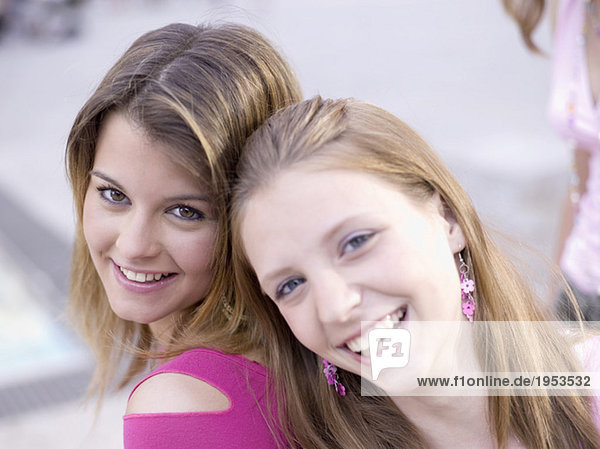 Two teenage girls (16-17) smiling
