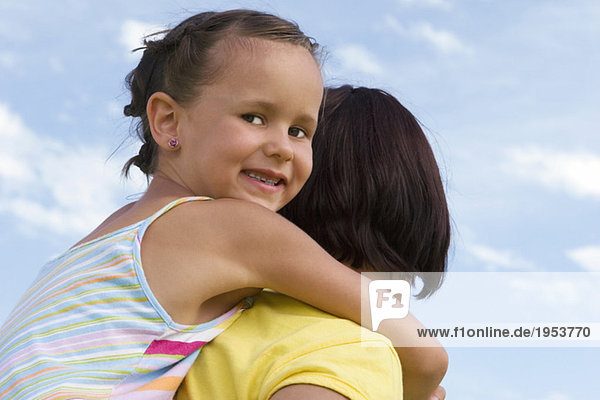 Mother carrying daughter on back  portrait
