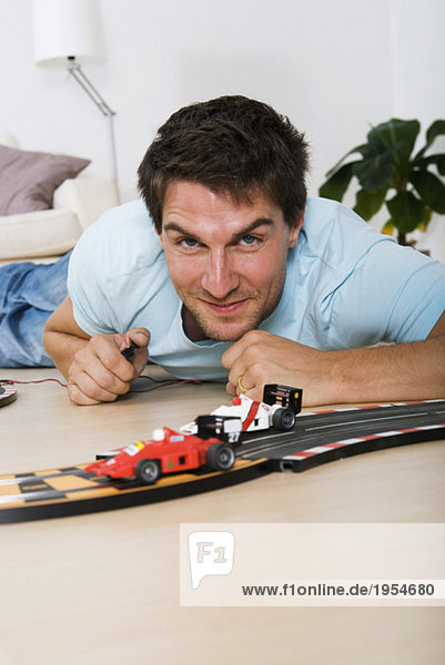 Man playing with toy cars