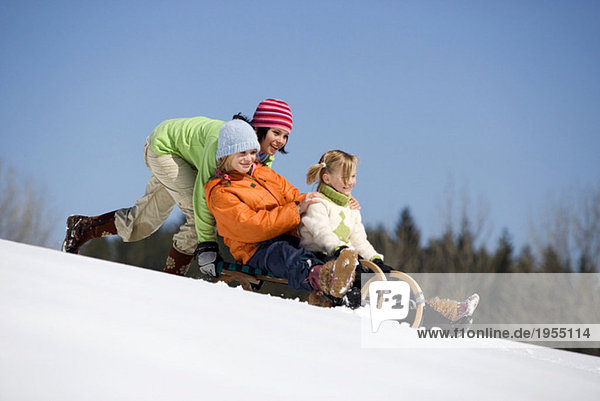 Three children on sledge
