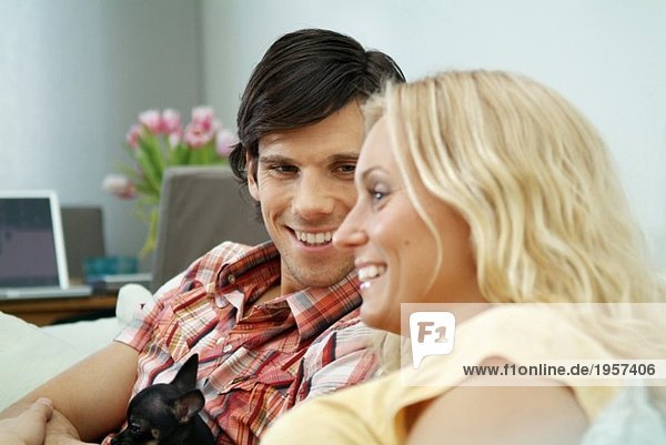 Young couple sitting in couch