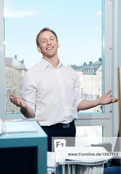 Guy in an office stretching his arms
