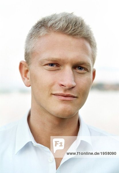 Portrait of blonde young man in white shirt