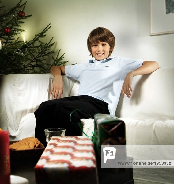 Boy sitting in a couch on Christmas eve