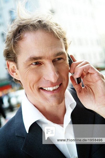 Positive businessman speaks on his mobile