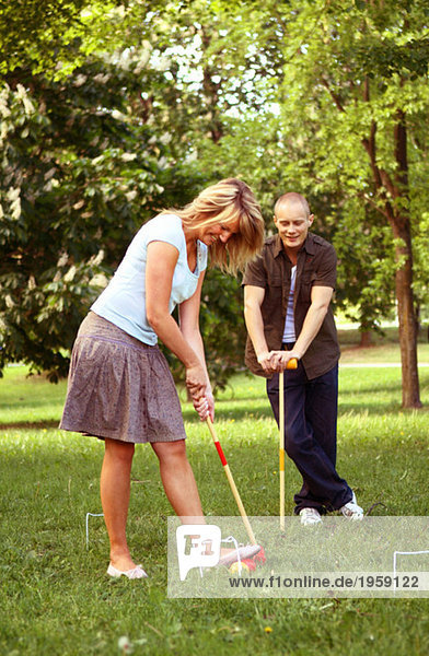 Mädchen und Mann beim Golfen
