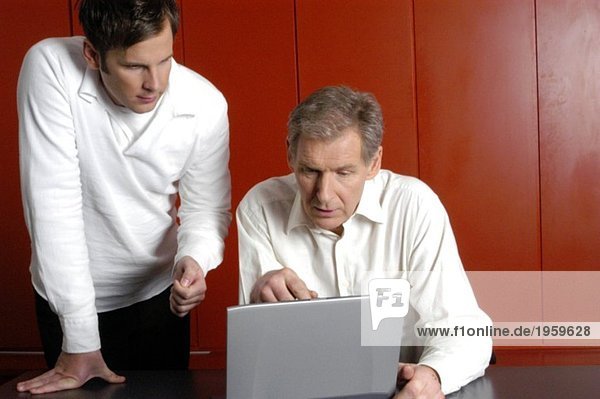 Two men looking at computer