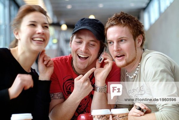 Three friends listening to message