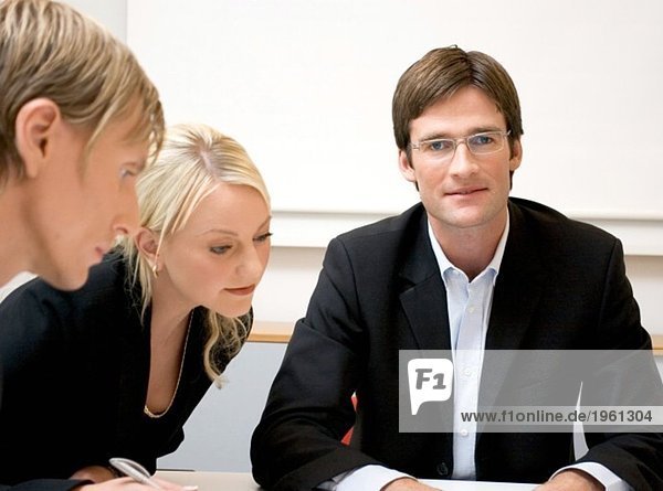 Three people in the meeting room