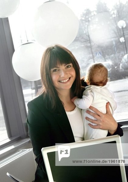 Businesswoman with baby