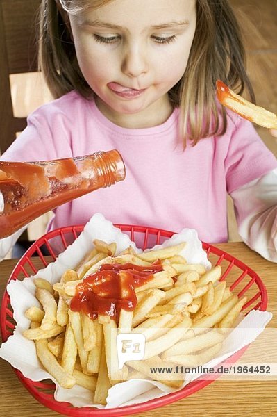 Girl eating chips with ketchup