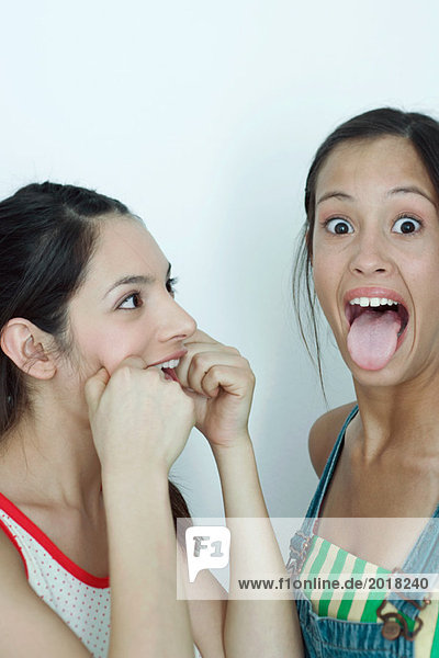 Two young female friends making faces portrait