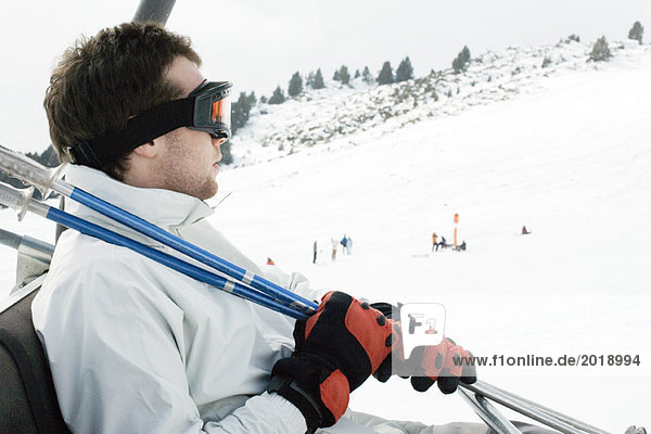 Young man taking ski lift