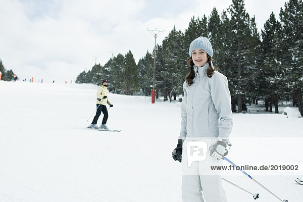 Teenage girl on skis  smiling at camera