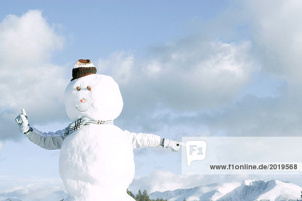 Snowman  person's arms emerging from behind  pointing in different directions