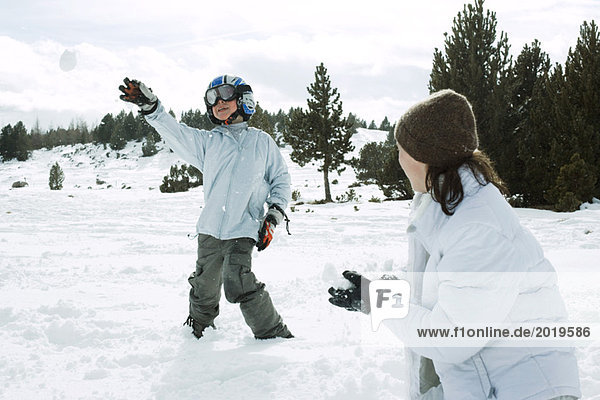 Young friends having snowball fight  action shot