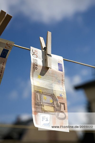Money hanging on a washing line