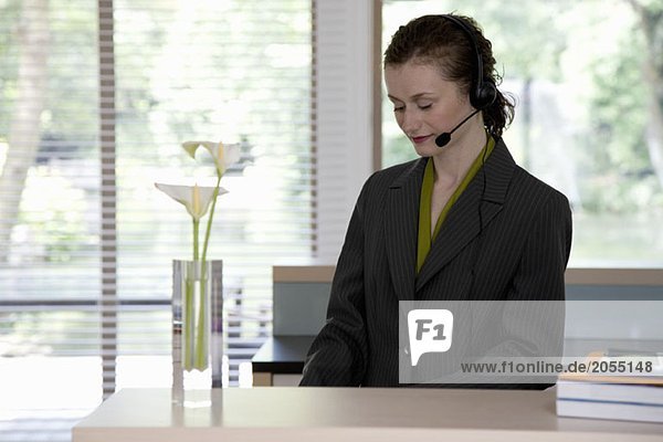 A young woman wearing a telephone headset