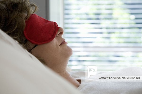 A woman sleeping with a sleep mask
