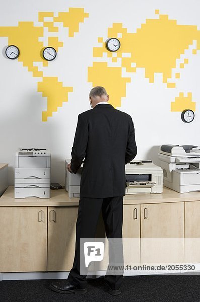 A man using a photocopier at work