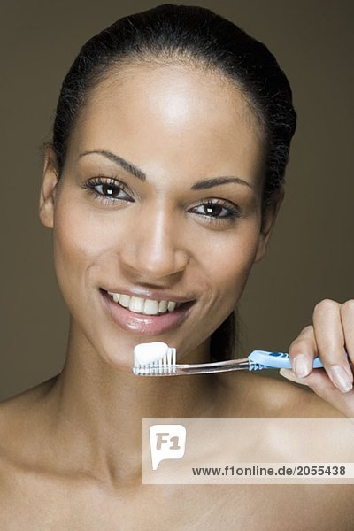 A woman holding a toothbrush