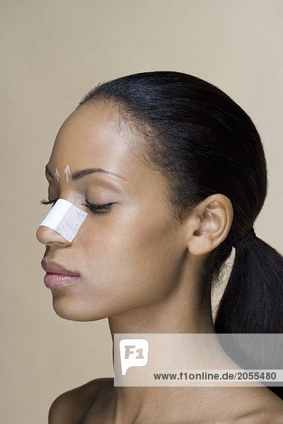 Portrait of a woman with her nose bandaged