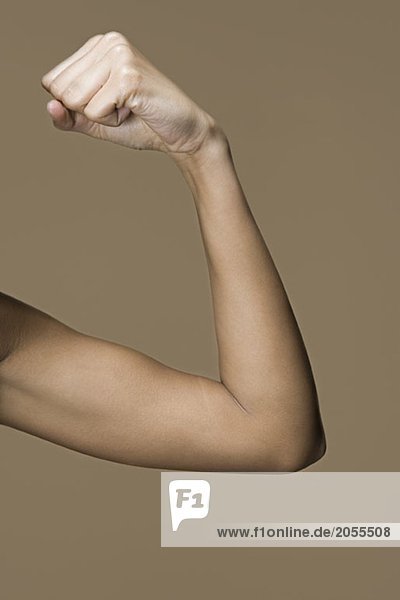 A woman flexing her bicep
