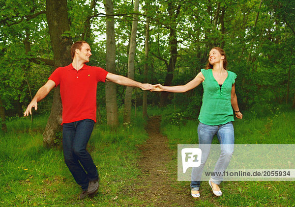 Girl and guy running hand in hand