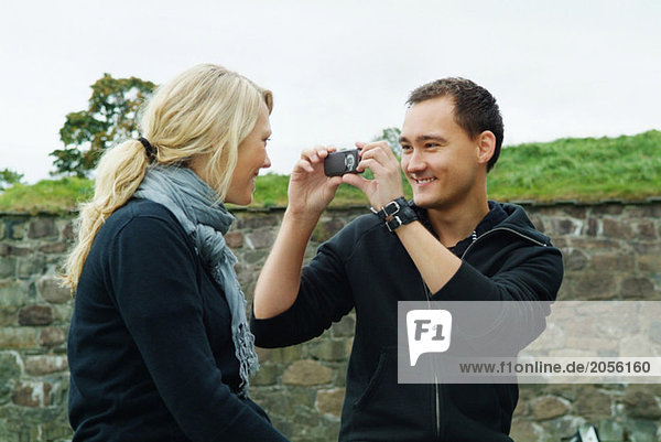 Guy taking a picture of girl