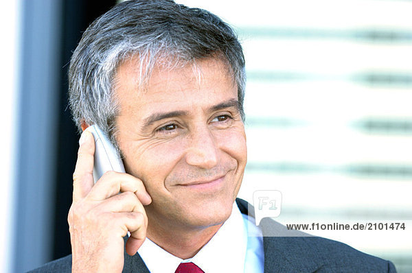 Mature businessman using mobile phone  close-up