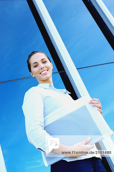 Young businesswoman holding file  low angle view