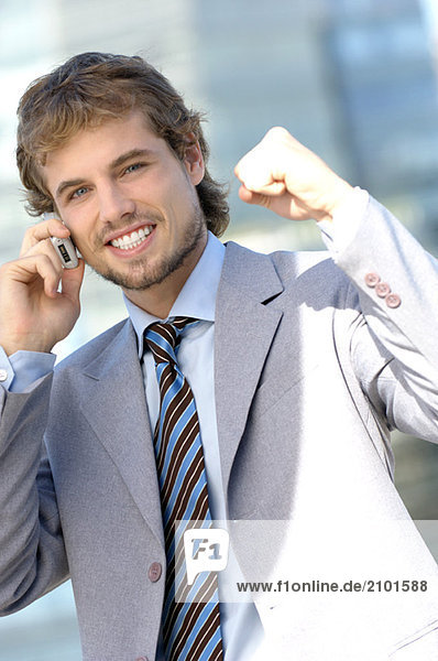 Young businessman using mobile phone  portrait