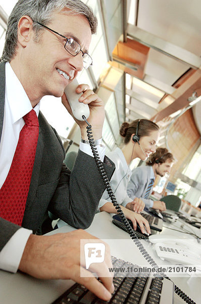 Business people working in office  smiling