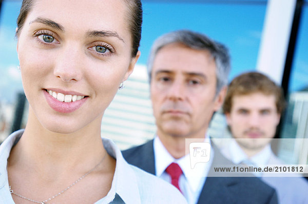 Business people standing in row  smiling  portrait