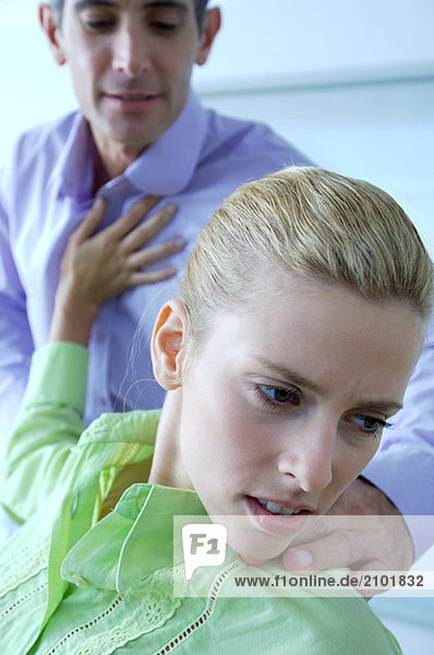 Female executive pushing male colleague in office