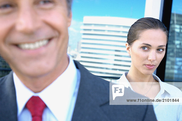 Businesswoman staring at businessman in office