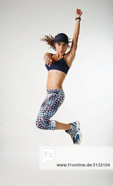 Woman athlete jumps in studio