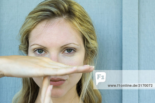 Woman making time out signal with hands  close-up
