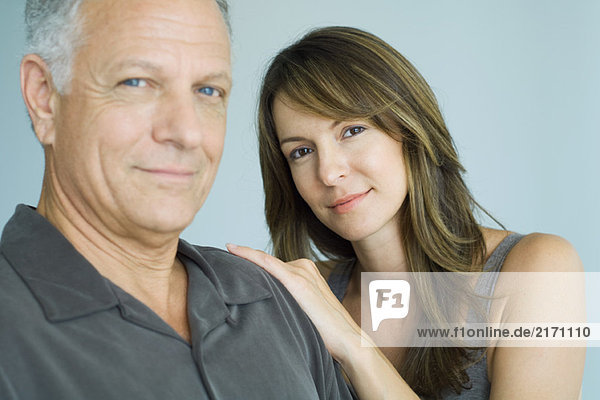Mature father and adult daughter smiling at camera  portrait