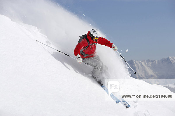 Austria  Saalbach  male skier turning in snow on slope