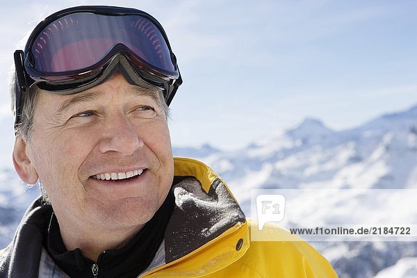 Mature male in ski-wear on mountain  close-up  portrait