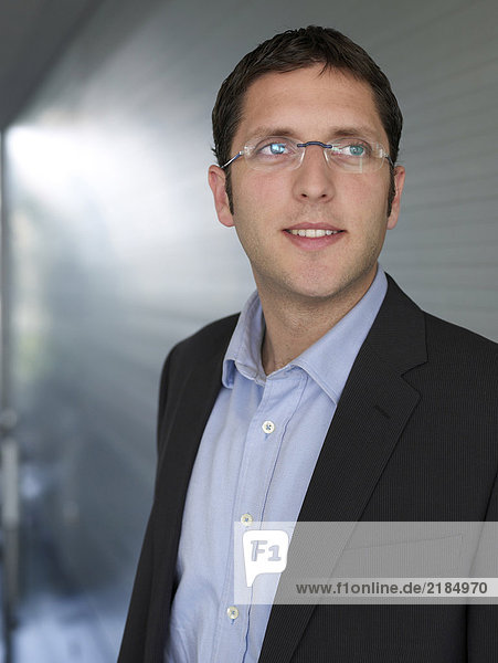 Young businessman wearing spectacles  smiling