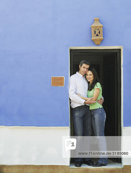 Paar umarmt die Tür  lächelnd  Portrait